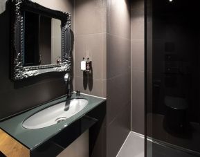 Guest bathroom with shower and free toiletries at Bloc Hotel.