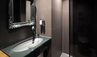 Guest bathroom with shower and free toiletries at Bloc Hotel.