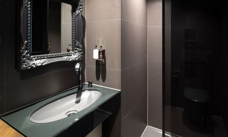 Guest bathroom with shower and free toiletries at Bloc Hotel.