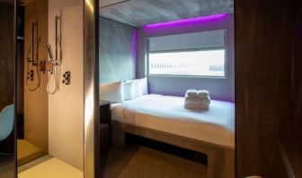 Day use room with work desk, private bathroom and window with view to the airport at Bloc Hotel.