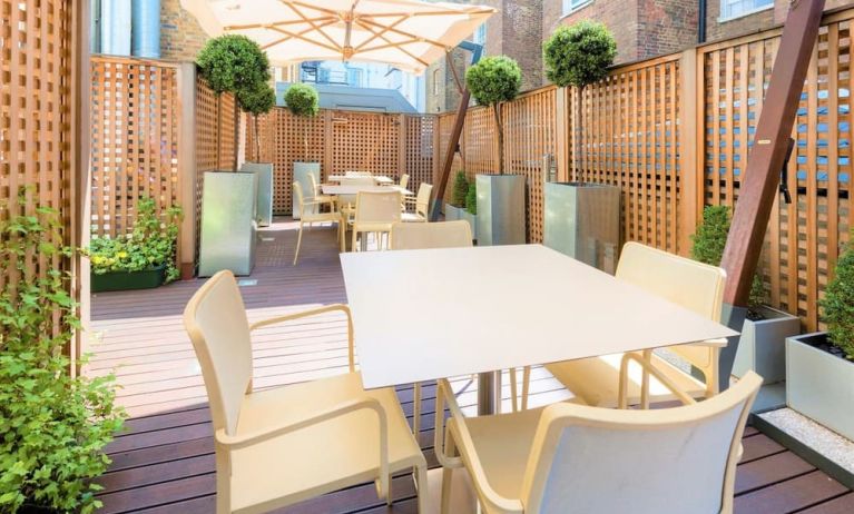 Outdoor patio with sitting area perfect for co-working at Hotel Indigo London Paddington,