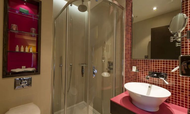 Guest bathroom with shower and free toiletries at Hotel Indigo London Paddington,