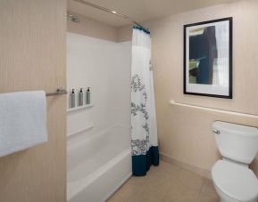 Guest bathroom with shower and tub at Residence Inn By Marriott Portland Airport At Cascade Station.