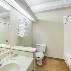 Guest bathroom with shower and tub at Hawthorn Suites By Wyndham El Paso Airport.