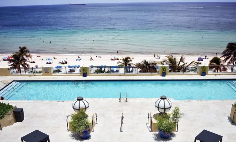 Refreshing outdoor pool with ocean view at The Atlantic Hotel & Spa.