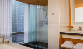 Guest bathroom with shower and tub at Courtyard By Marriott New York Manhattan/Central Park.