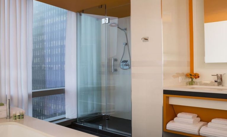 Guest bathroom with shower and tub at Courtyard By Marriott New York Manhattan/Central Park.