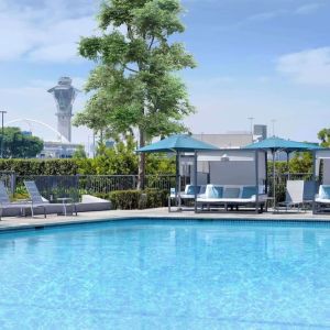 Refreshing outdoor pool with loungers and cabanas at Hyatt Regency Los Angeles International Airport.