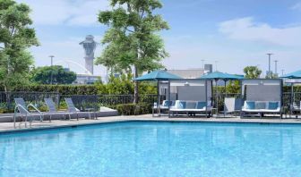 Refreshing outdoor pool with loungers and cabanas at Hyatt Regency Los Angeles International Airport.