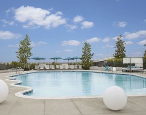 Refreshing outdoor pool with loungers and cabanas at Hyatt Regency Los Angeles International Airport.