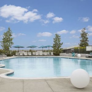 Refreshing outdoor pool with loungers and cabanas at Hyatt Regency Los Angeles International Airport.