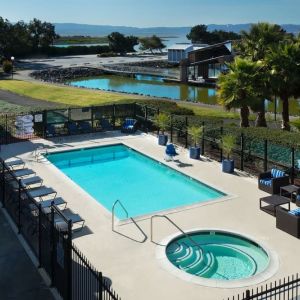 Refreshing outdoor pool and spa tub at The Marina Inn On San Francisco Bay.