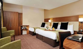 Day use twin room with work desk and lounge seating at Mercure London Bloomsbury.