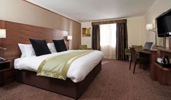 Day use room with TV screen, work desk and private bathroom at Mercure London Bloomsbury.