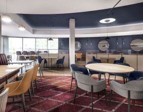 Dining area with comfortable seating, perfect for co-working at Hyatt Place London Heathrow Airport.