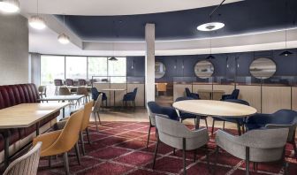 Dining area with comfortable seating, perfect for co-working at Hyatt Place London Heathrow Airport.