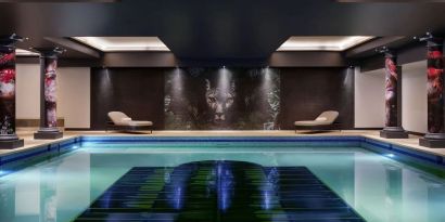 Relaxing indoor pool with lounge chairs at NYX Hotel London Holborn By Leonardo.