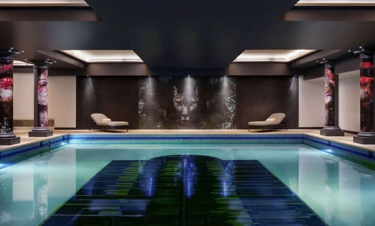 Relaxing indoor pool with lounge chairs at NYX Hotel London Holborn By Leonardo.