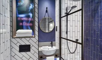 Guest bathroom with shower at NYX Hotel London Holborn By Leonardo.