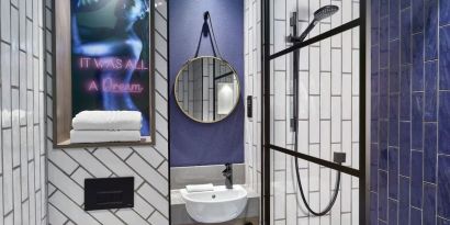 Guest bathroom with shower at NYX Hotel London Holborn By Leonardo.