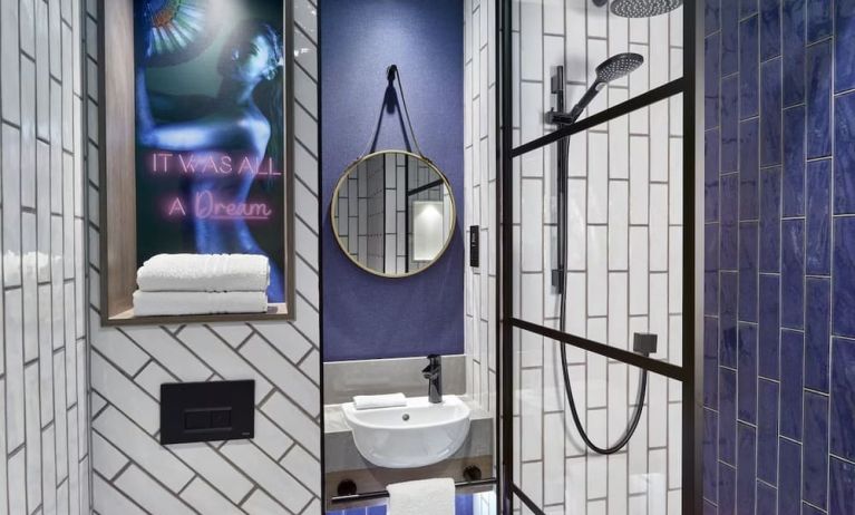 Guest bathroom with shower at NYX Hotel London Holborn By Leonardo.