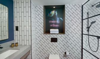 Guest bathroom with shower at NYX Hotel London Holborn By Leonardo.