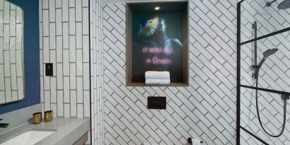 Guest bathroom with shower at NYX Hotel London Holborn By Leonardo.