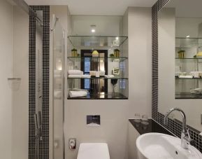 Guest bathroom with shower and free toiletries at Leonardo Royal St Paul's Hotel.