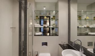 Guest bathroom with shower and free toiletries at Leonardo Royal St Paul's Hotel.