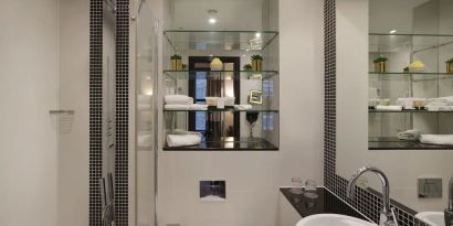 Guest bathroom with shower and free toiletries at Leonardo Royal St Paul's Hotel.