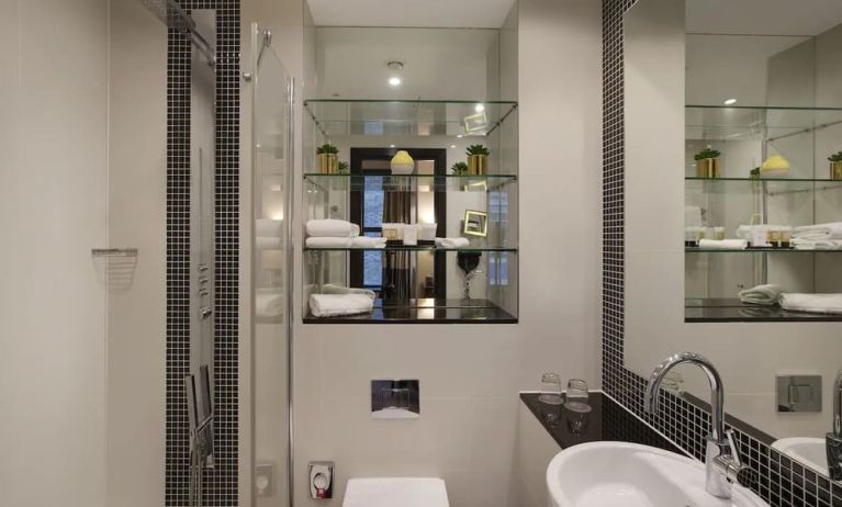 Guest bathroom with shower and free toiletries at Leonardo Royal St Paul's Hotel.