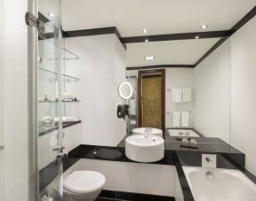 Guest bathroom with tub and free toiletries at Leonardo Royal St Paul's Hotel.