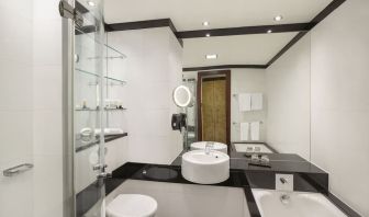 Guest bathroom with tub and free toiletries at Leonardo Royal St Paul's Hotel.