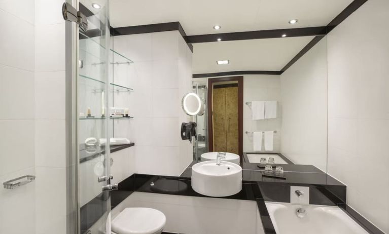 Guest bathroom with tub and free toiletries at Leonardo Royal St Paul's Hotel.