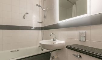 Guest bathroom with combined tub and shower at Thistle Express London, Luton.