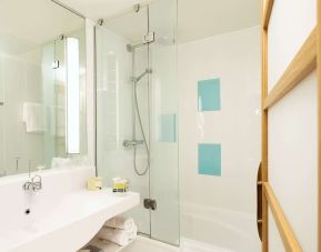 Guest bathroom with shower at Novotel Manchester West.