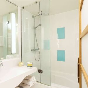 Guest bathroom with shower at Novotel Manchester West.