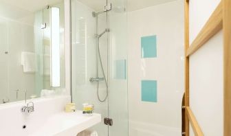 Guest bathroom with shower at Novotel Manchester West.