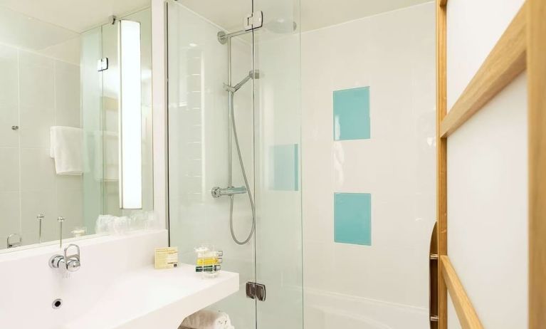 Guest bathroom with shower at Novotel Manchester West.