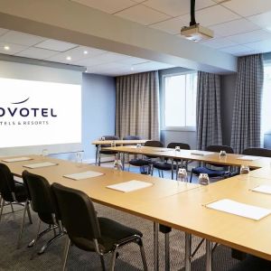 Professional meeting room with U shaped table at Novotel Manchester West.