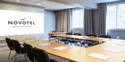 Professional meeting room with U shaped table at Novotel Manchester West.