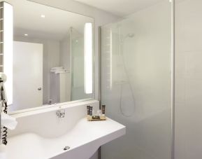 Private guest bathroom with free toiletries at Novotel Manchester West.