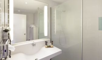 Private guest bathroom with free toiletries at Novotel Manchester West.