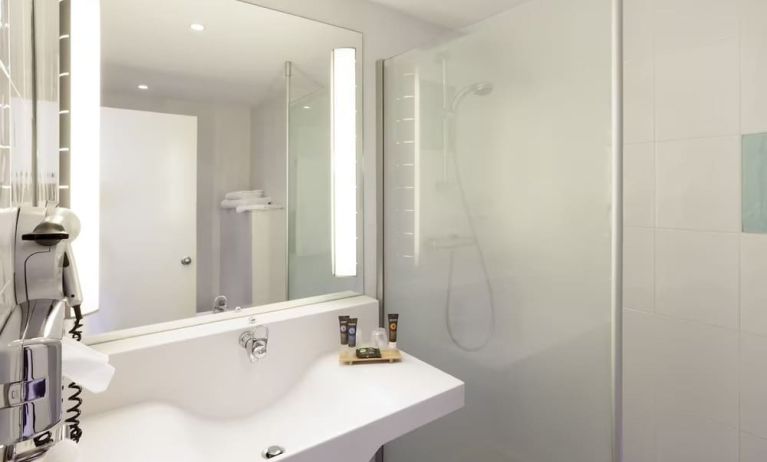 Private guest bathroom with free toiletries at Novotel Manchester West.