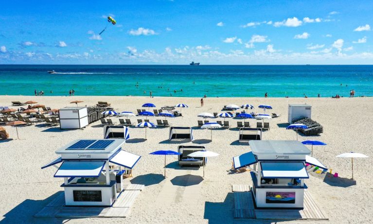 On the beach with ample sun loungers at The Sagamore Hotel South Beach.