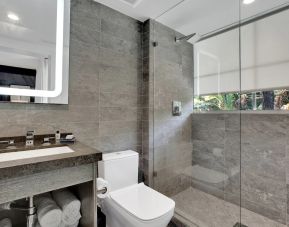 Guest bathroom with shower at The Sagamore Hotel South Beach.