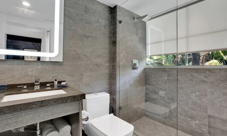 Guest bathroom with shower at The Sagamore Hotel South Beach.