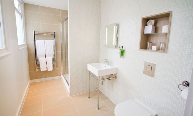 Guest bathroom with shower and free toiletries at The Wesley Euston Hotel.