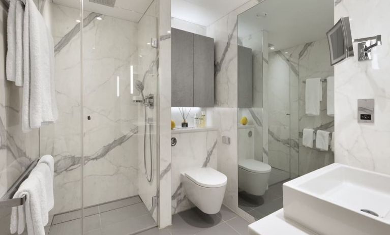 Guest bathroom with shower and free toiletries at Tower Suites By Blue Orchid Hotels.