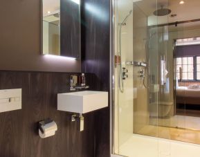 Guest bathroom with shower and free toiletries at Bloc Hotel Birmingham.